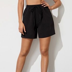 Bundle of two long sweat shorts.